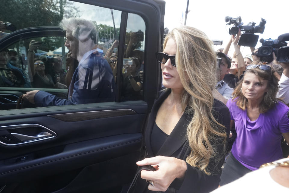 Attorneys Lindsey Halligan, foreground, and Evan Corcoran, left rear, leave the Paul G. Rogers Federal Building and U.S. Courthouse in West Palm Beach, Fla., Thursday, Sept. 1, 2022. A federal judge has heard arguments on whether to appoint an outside legal expert to review government records seized by the FBI last month in a search of former President Donald Trump's Florida home. There was no immediate ruling after arguments Thursday. (AP Photo/Wilfredo Lee)