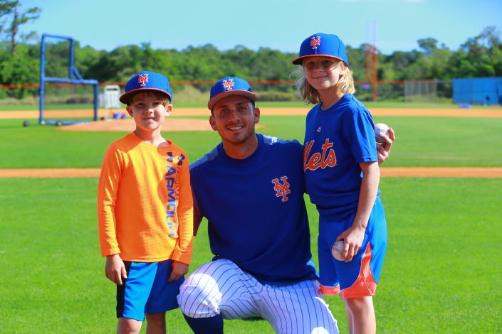 <p>New York Mets player T.J. Rivera poses for a photo with two fans during spring training workouts in Port St. Lucie, Fla., Feb. 23, 2018. The youngsters were given an opportunity to participate in drillls with Rivera. (Photo: Gordon Donovan/Yahoo News) </p>