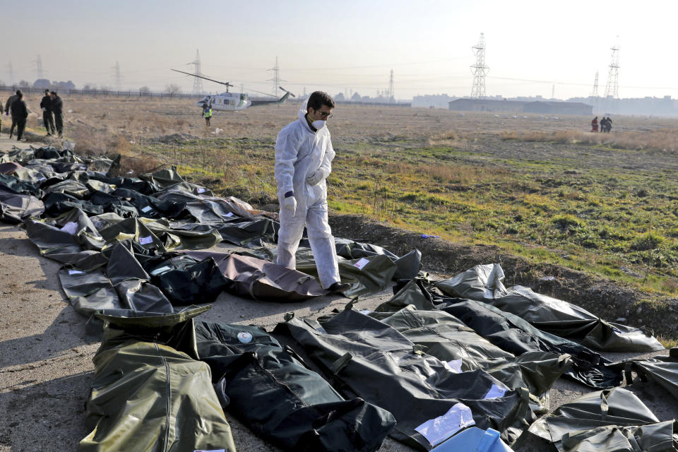 A forensic investigator works at the scene of a Ukrainian plane crash as bodies of the victims are collected, in Shahedshahr, southwest of the capital Tehran, Iran, Wednesday, Jan. 8, 2020.(Photo: Ebrahim Noroozi/AP)