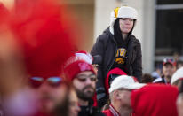 Iowa fan Jausten Baumgarn, 12, of Lake Park, Iowa, sits atop the shoulders of Sterling Haack, 17, of Maurice, Iowa, while waiting to watch the Nebraska team arrive before an NCAA college football game Friday, Nov. 26, 2021, at Memorial Stadium in Lincoln, Neb. (AP Photo/Rebecca S. Gratz)