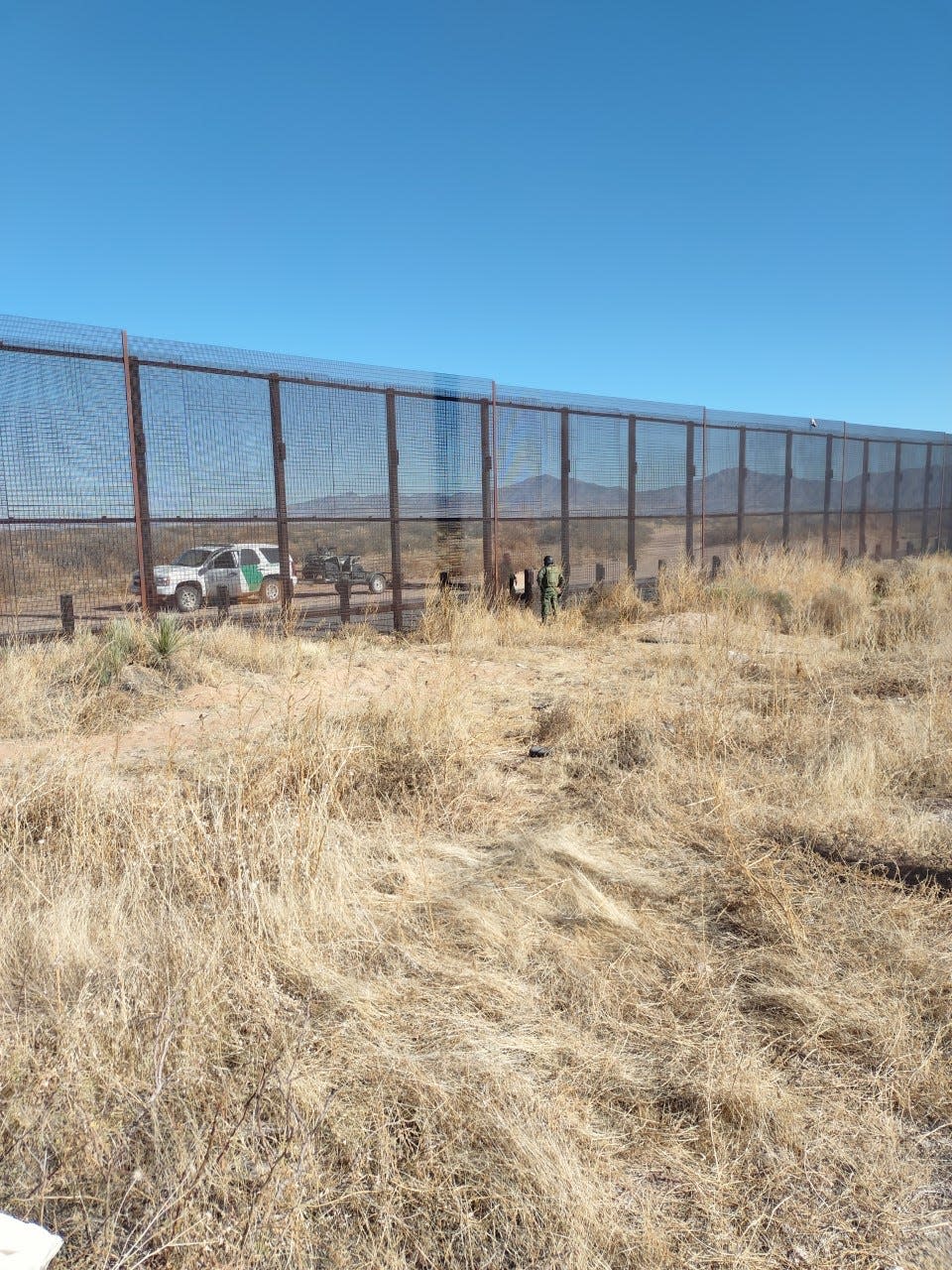 Border agents from the United States and Mexico chat while on opposite sides of the border wall near Sunland Park, New Mexico, on Dec. 29, 2021.