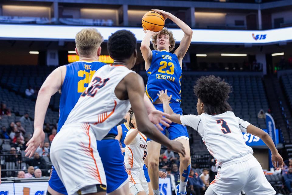 Ripon Christian Knights Jace Beidleman (23) makes a jump shot over Fortune Early College Panthers guard Jabari Pugh (3) in the second half in CIF Sac-Joaquin Section Division V boys basketball Championship on Saturday, Feb. 25, 2023, at Golden 1 Center in Sacramento. Beidleman had four points and 15 rebounds. The Knights won 58-54.