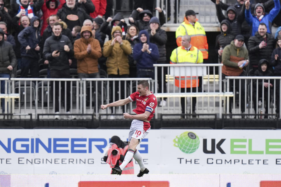 Wrexham's Paul Mullin celebrates scoring the opening during the English League Two soccer match between Wrexham and Mansfield Town at the SToK Cae Ras in Wrexham, Wales, Friday, March 29, 2024. (Jacob King/PA via AP)