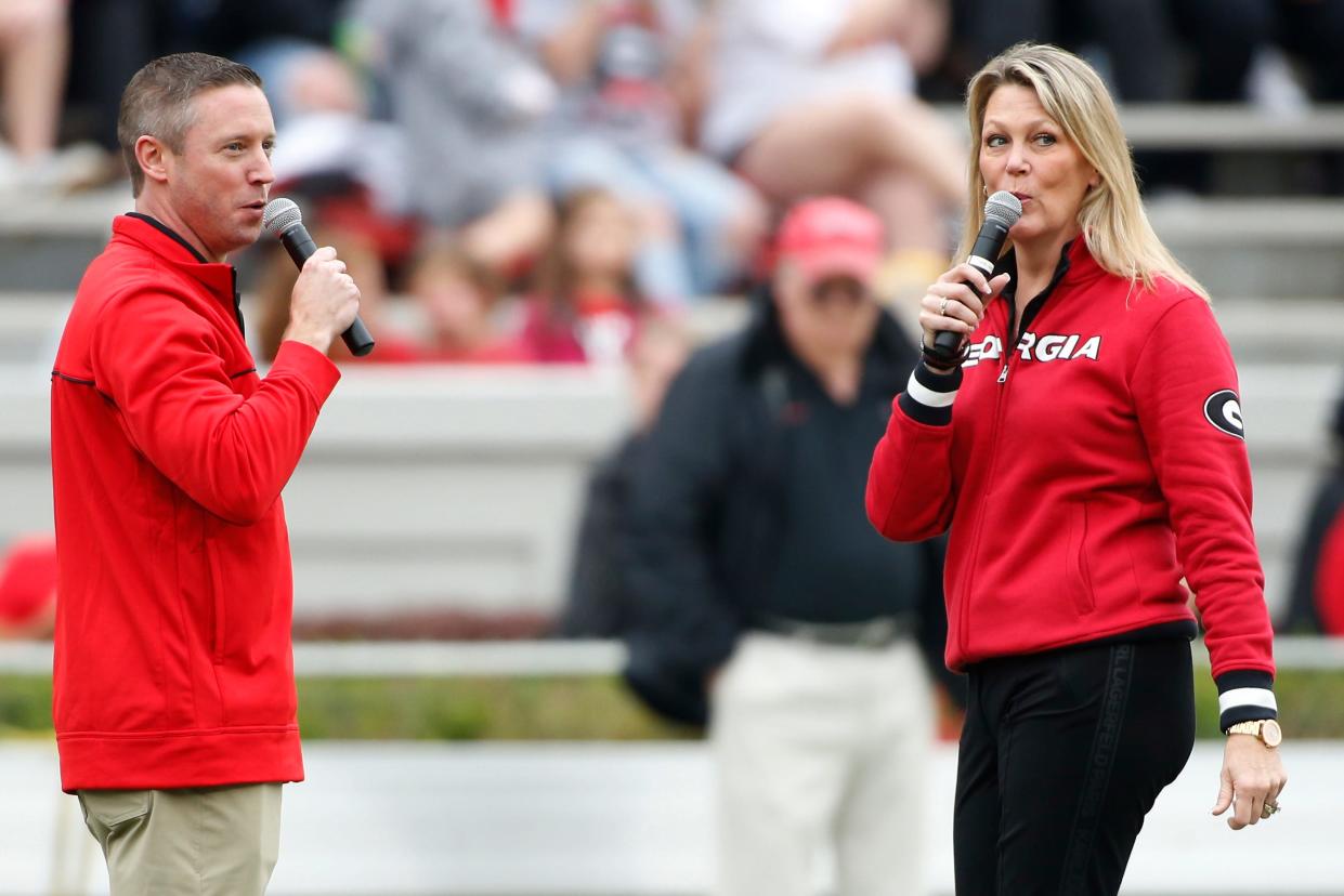 The new men's and women's basketball coaches Mike White and Katie Abrahamson-Henderson call the Dawgs before the start of the G-Day football game in Athens, Ga., on Saturday, April 16, 2022.