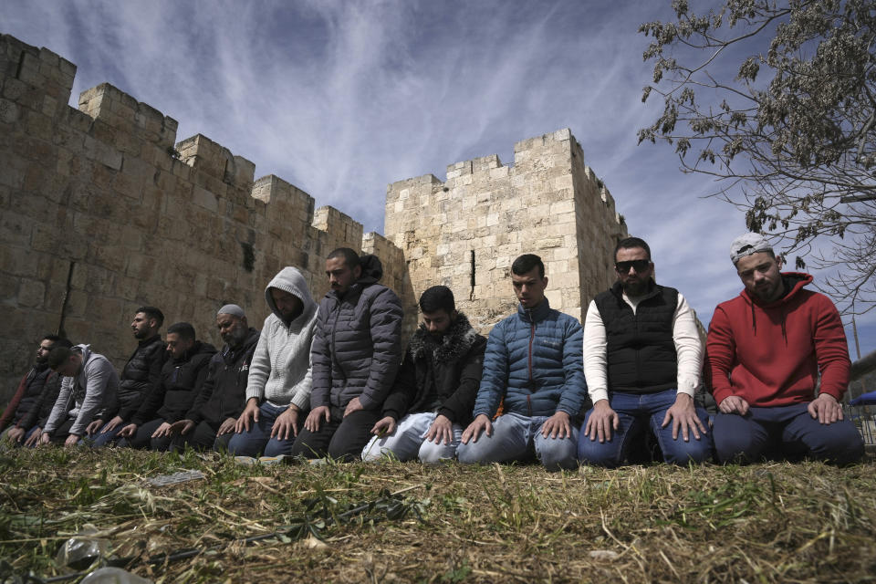 Palestinian Muslims pray outside of the walls of the Old City of Jerusalem after Israeli police denied their entry to the Al-Aqsa Mosque compound for Friday prayers, Friday, March 1, 2024. (AP Photo/Mahmoud Illean)