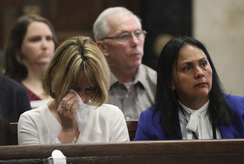 Chicago Police Cmdr. Paul Bauer's widow Erin Bauer, left, wipes away tears during closing statements during closing statements in Shomari Legghette's murder trial at the Leighton Criminal Courthouse, Friday, March 13, 2020, in Chicago. Legghette is on trial for first-degree murder in the Feb. 13, 2018, killing of Bauer. (Antonio Perez/Chicago Tribune via AP, Pool)