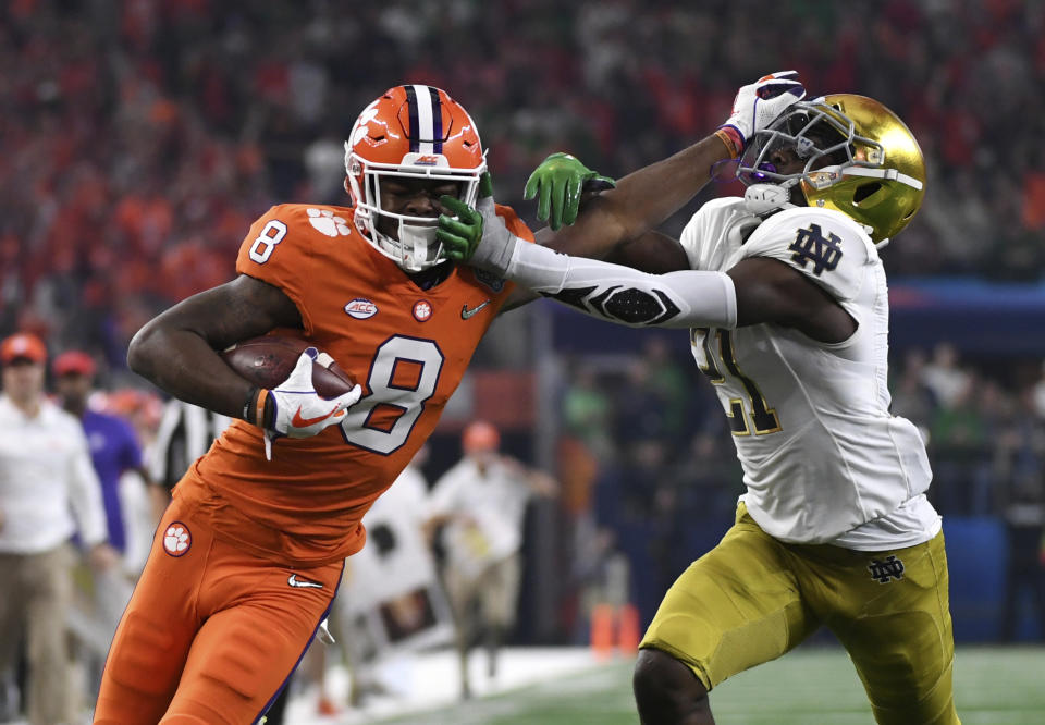 Clemson wide receiver Justyn Ross (8) fights off a tackle attempt by Notre Dame safety Jalen Elliott (21) and gets into the end zone for a touchdown in the first half of the NCAA Cotton Bowl semi-final playoff football game, Saturday, Dec. 29, 2018, in Arlington, Texas. (AP Photo/Jeffrey McWhorter)