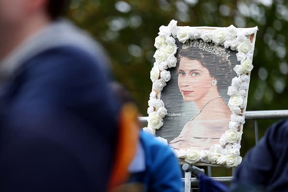 WINDSOR, ENGLAND - SEPTEMBER 19: Detailed view as a picture of Her Majesty Queen Elizabeth II is seen on September 19, 2022 in Windsor, England. The committal service at St George's Chapel, Windsor Castle, took place following the state funeral at Westminster Abbey. A private burial in The King George VI Memorial Chapel followed. Queen Elizabeth II died at Balmoral Castle in Scotland on September 8, 2022, and is succeeded by her eldest son, King Charles III. (Photo by Alex Pantling/Getty Images)