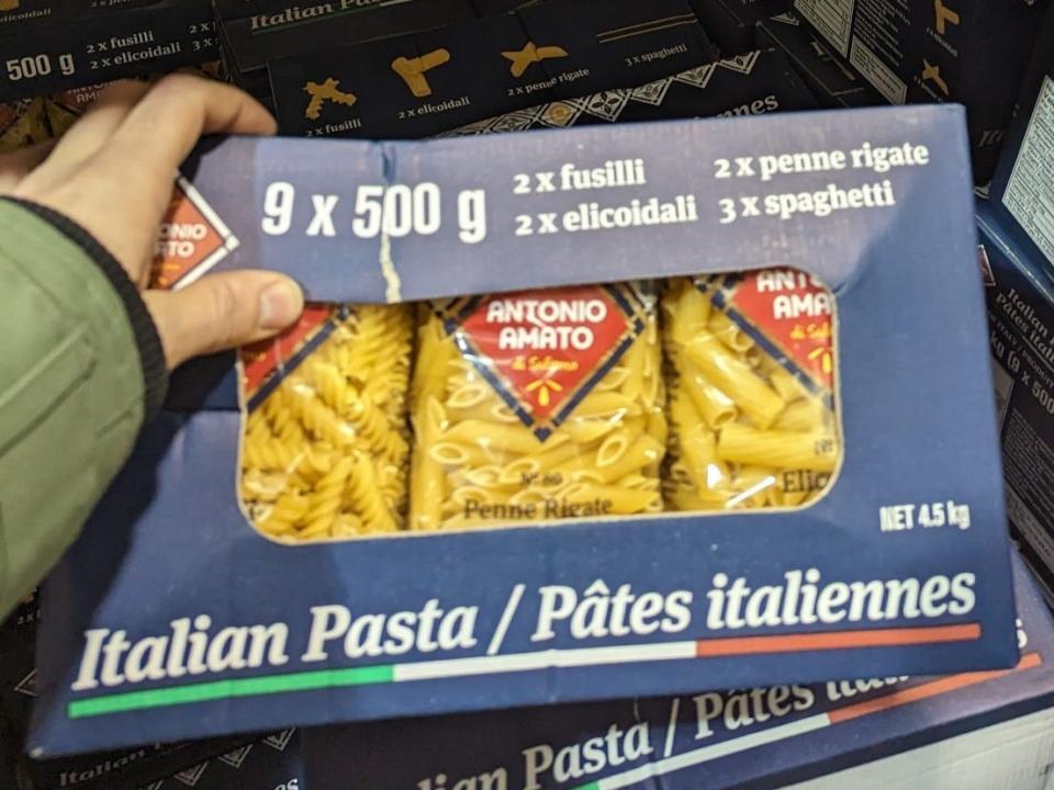 The writer holds a box of Italian pasta