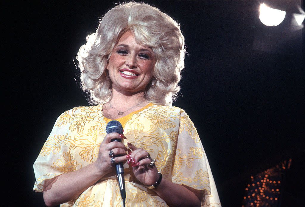 los angeles circa 1975 country singer dolly parton performs onstage wearing a yellow dress, circa 1975, los angeles, california photo by michael ochs archivesgetty images