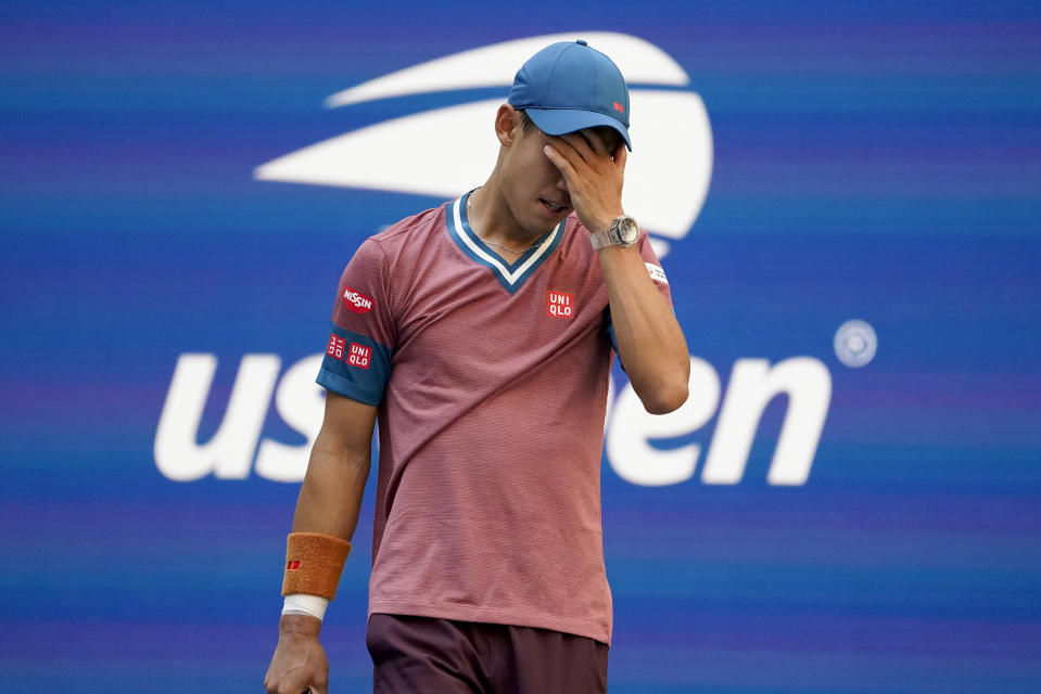 Kei Nishikori, of Japan, reacts after losing a point to Novak Djokovic, of Serbia, during the third round of the US Open tennis championships, Saturday, Sept. 4, 2021, in New York. (AP Photo/John Minchillo)