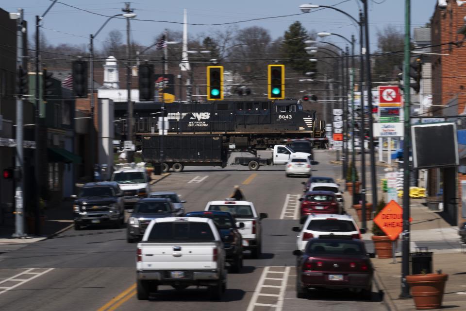 A train moves through East Palestine, Ohio, Tuesday, April 4, 2023. Almost 3 months after a fiery Norfolk Southern train derailment blackened the skies, sent residents fleeing and thrust East Palestine into a national debate over rail safety, residents say they are still living in limbo. (AP Photo/Matt Rourke)