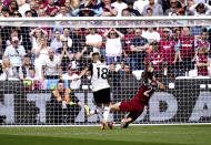 Fulham's Andreas Pereira scores his side's first goal of the game during the English Premier League soccer match between West Ham United and Fulham, at the London Stadium, London, Sunday April 14, 2024. (John Walton/PA via AP)