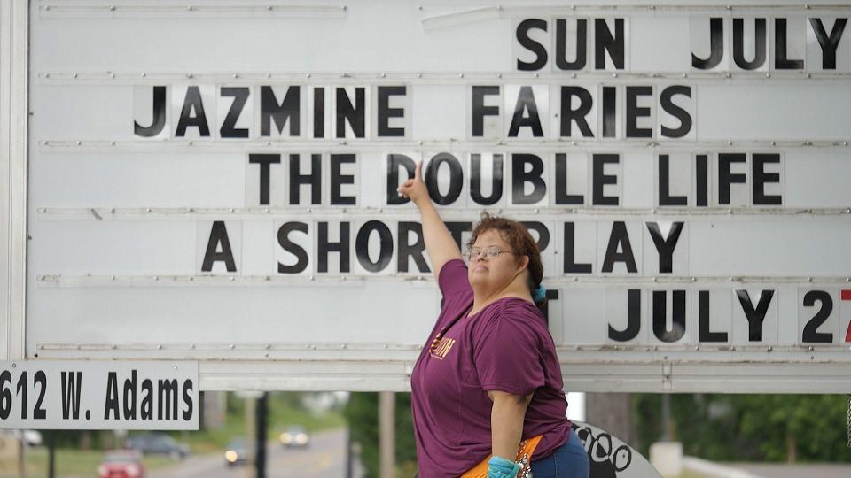 Jazmine Faries in front of a marquee promoting her original stage play "The Double Life." "Iron Family" follows Jazmine and her family as they prepare for the sixth season of the play which mirrors Jazmine's desire for independence and love.