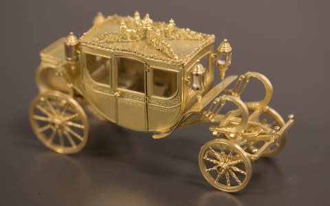Inside a hinged top is a miniature replica of one of the Queen's state carriages  - Credit: Heathcliff O'Malley