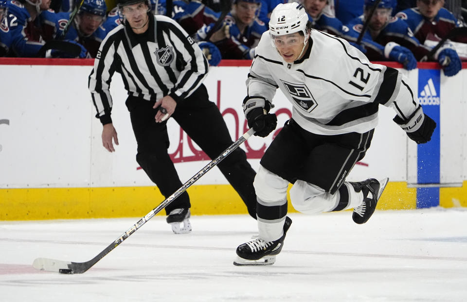 Los Angeles Kings left wing Trevor Moore (12) drives to the net in the second period of an NHL hockey game against the Colorado Avalanche, Friday, Jan. 26, 2024, in Denver. (AP Photo/David Zalubowski)