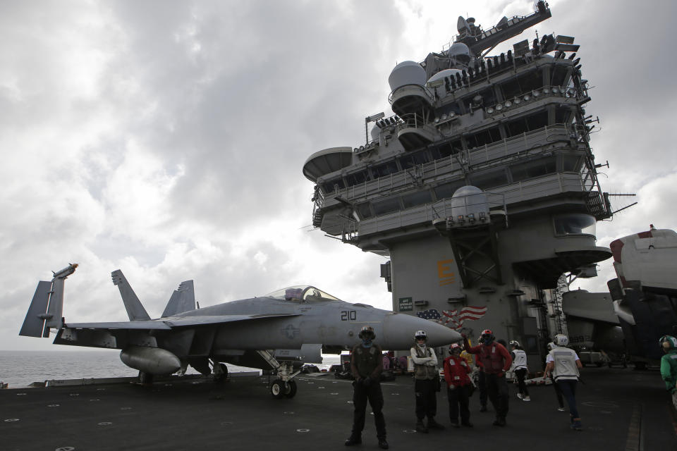 An F/A-18 Super Hornet fighter jet is seen on the deck of the U.S. Navy USS Ronald Reagan in the South China Sea, Tuesday, Nov. 20, 2018. China is allowing a U.S. Navy aircraft carrier and its battle group to make a port call in Hong Kong after it turned down similar request amid tensions with Washington. (AP Photo/Kin Cheung)