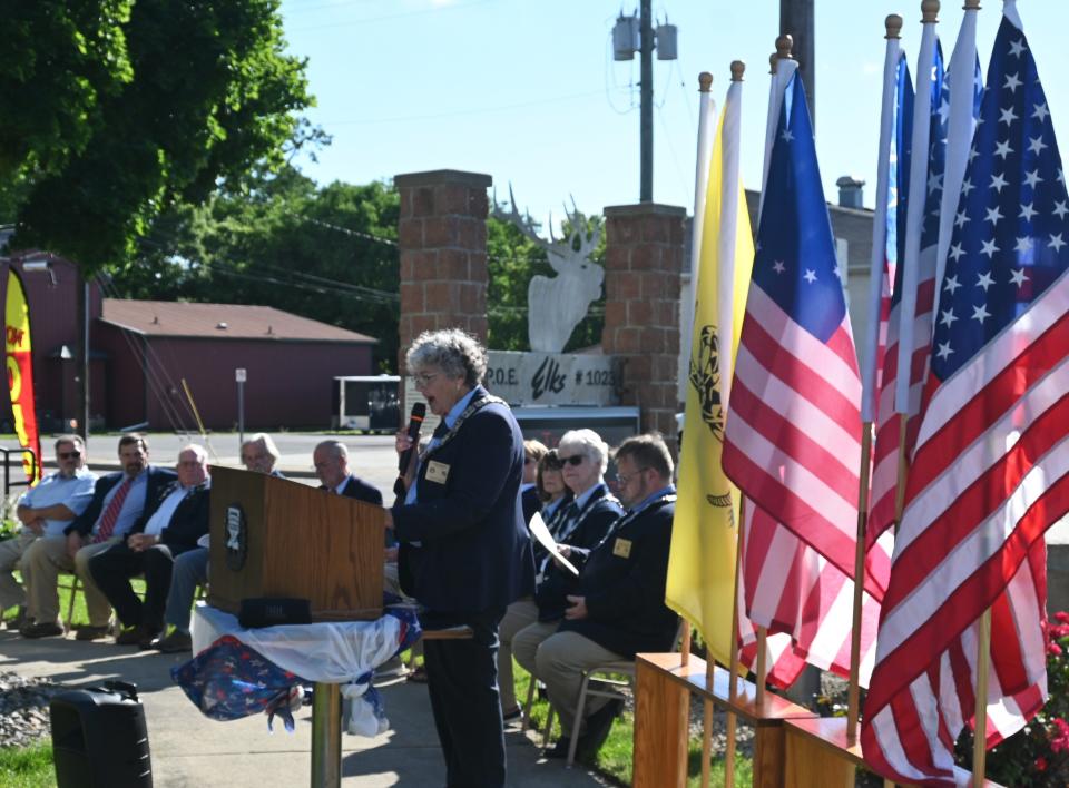 Elks Exalted Ruler Kathy Modert welcomes guest to the Flag Day celebration Friday evening.