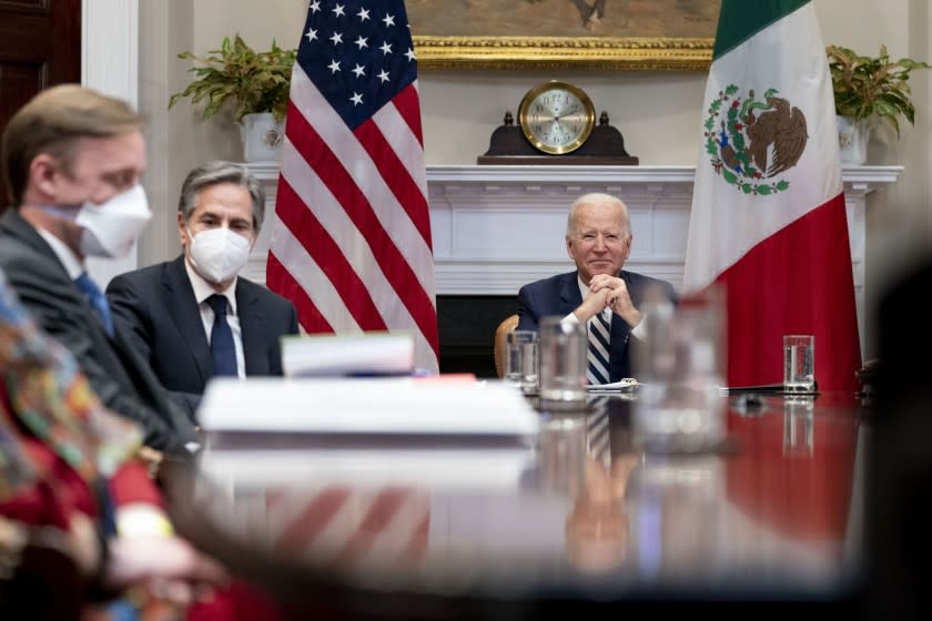 President Joe Biden, accompanied by White House national security adviser Jake Sullivan, left, and Secretary of State Antony Blinken, second from left, attends a virtual meeting with Mexican President Andres Manuel Lopez Obrador, in the Roosevelt Room of the White House, Monday, March 1, 2021, in Washington. (AP Photo/Andrew Harnik)