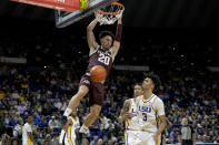 Texas A&M guard Andre Gordon (20) dunks against LSU forward Alex Fudge (3) during the first half of an NCAA college basketball game in Baton Rouge, La., Wednesday, Jan. 26, 2022. (AP Photo/Matthew Hinton)