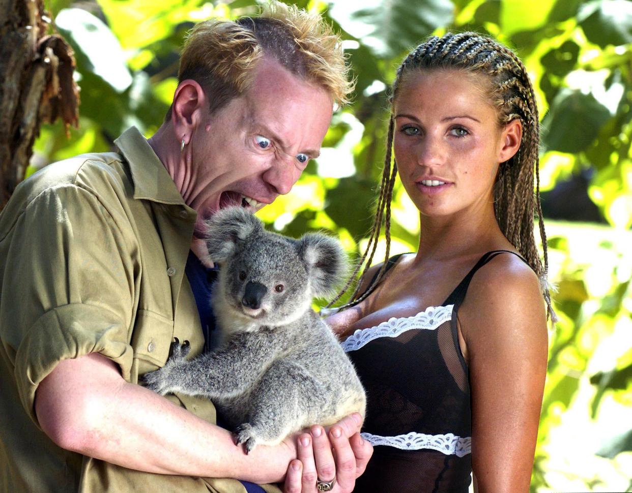 British celebrities model Katie Price aka Jordan, right,  and Johnny "Rotten" Lydon of the Sex Pistols get acquainted with a Koala at a wildlife park on the Gold Coast, Australia, Sunday, Jan. 25, 2004. The pair are competing with eight other celebrities in the British television program "I'm a Celebrity ... Get Me Out Of Here ! " which begins today in the Australian jungle near Murwillumbah, 200 kilometers (124 miles) south of Brisbane on Australia's east coast. Each celebrity will be voted for by the British public with the winner announced in the final show on Feb. 9. (AP Photo/Brian Cassey)