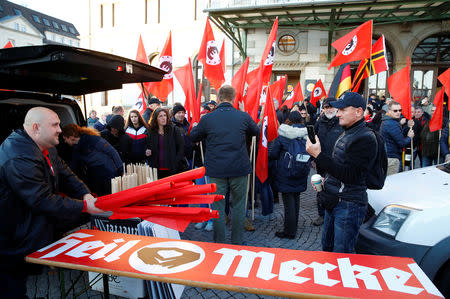 Protesters prepare before a demonstration during a visit of German Chancellor Angela Merkel in Chemnitz, Germany November 16, 2018. REUTERS/Axel Schmidt