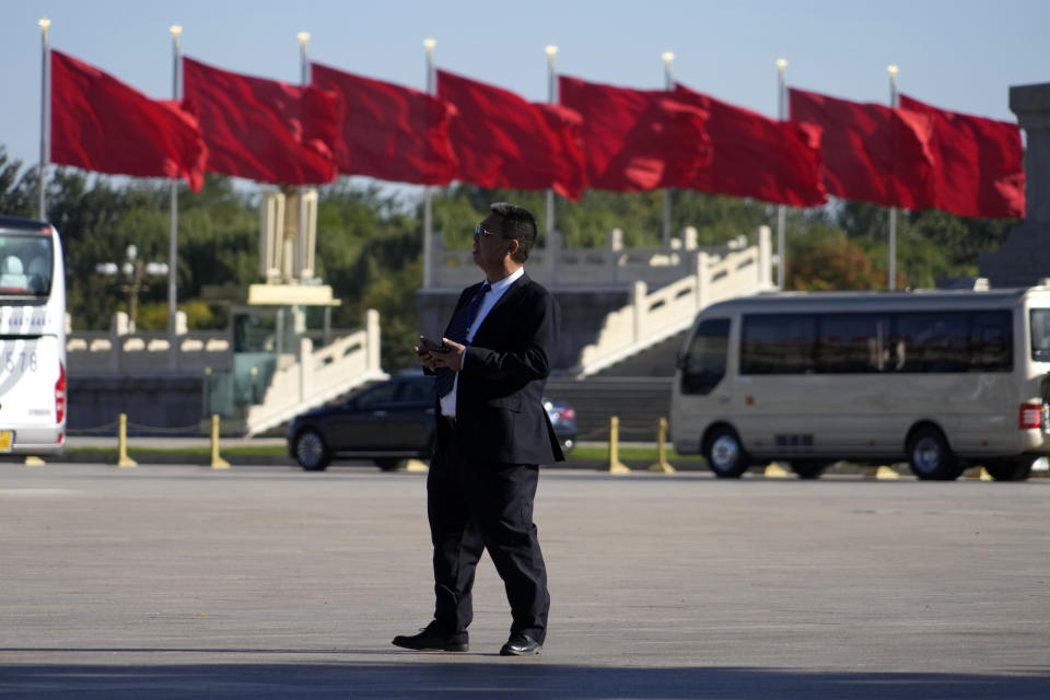 An attendee walks across Tiananmen Square ahead of the closing ceremony of the 20th National Congress of China's ruling Communist Party in Beijing, Saturday, Oct. 22, 2022. (AP Photo/Ng Han Guan)