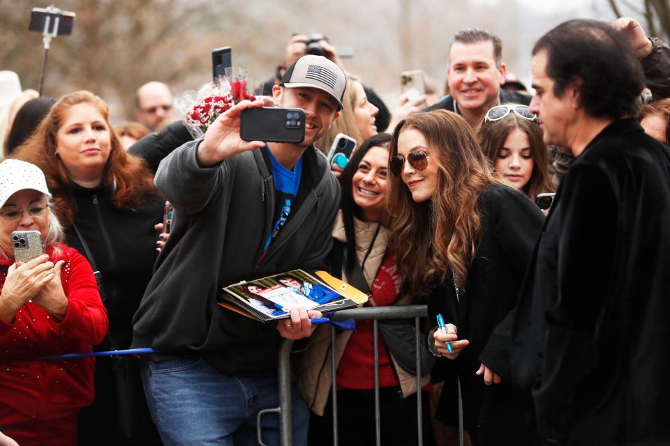 Lisa Marie Presley takes a photo with fans during a celebration of Elvis Presley's birthday on Jan. 8, 2023, on the front lawn of Graceland. Fans from around the world gathered to celebrate the King, who would have turned 88 on Jan. 8.