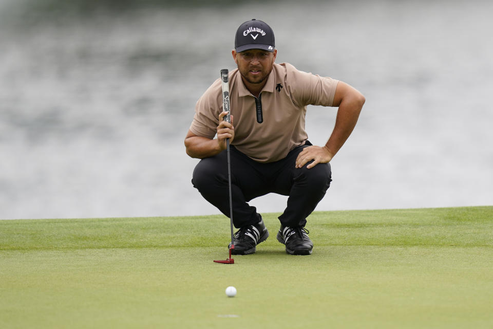 Xander Schauffele lines up a putt on the 14th hole during the first round of the Wells Fargo Championship golf tournament at the Quail Hollow Club Thursday, May 9, 2024, in Charlotte, N.C. (AP Photo/Erik Verduzco)