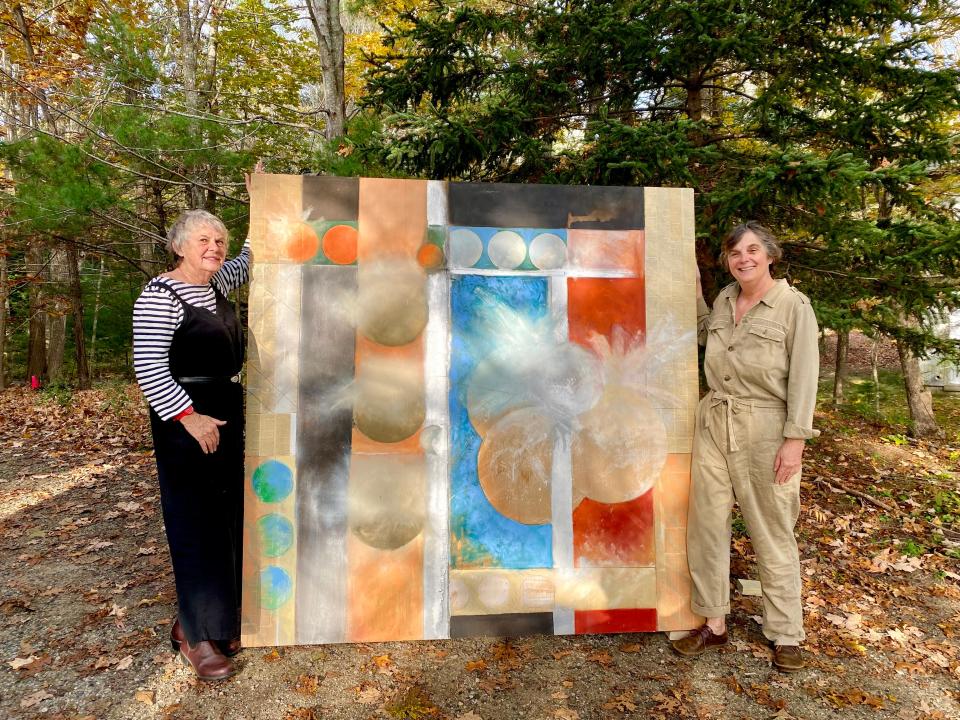 Sisters Hanna and Marjan Frank with one of Tim Beavis’ paintings being shown in the upcoming Fireworks Series.