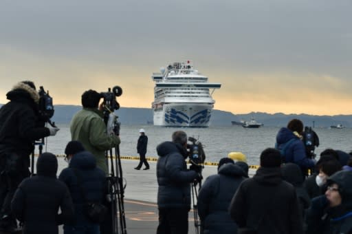 The media keep watch on the Diamond Princess cruise ship with over 3,000 people on board as it sits in quarantine at Yokohama port