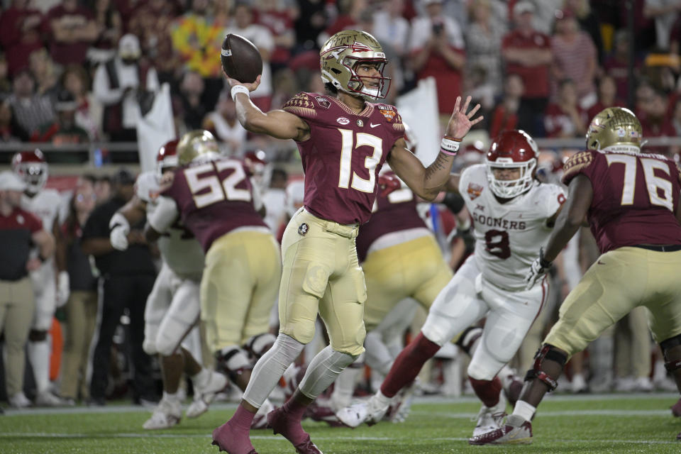 Florida State quarterback Jordan Travis (13) throws a pass during the first half of the Cheez-It Bowl NCAA college football game against Oklahoma, Thursday, Dec. 29, 2022, in Orlando, Fla. (AP Photo/Phelan M. Ebenhack)