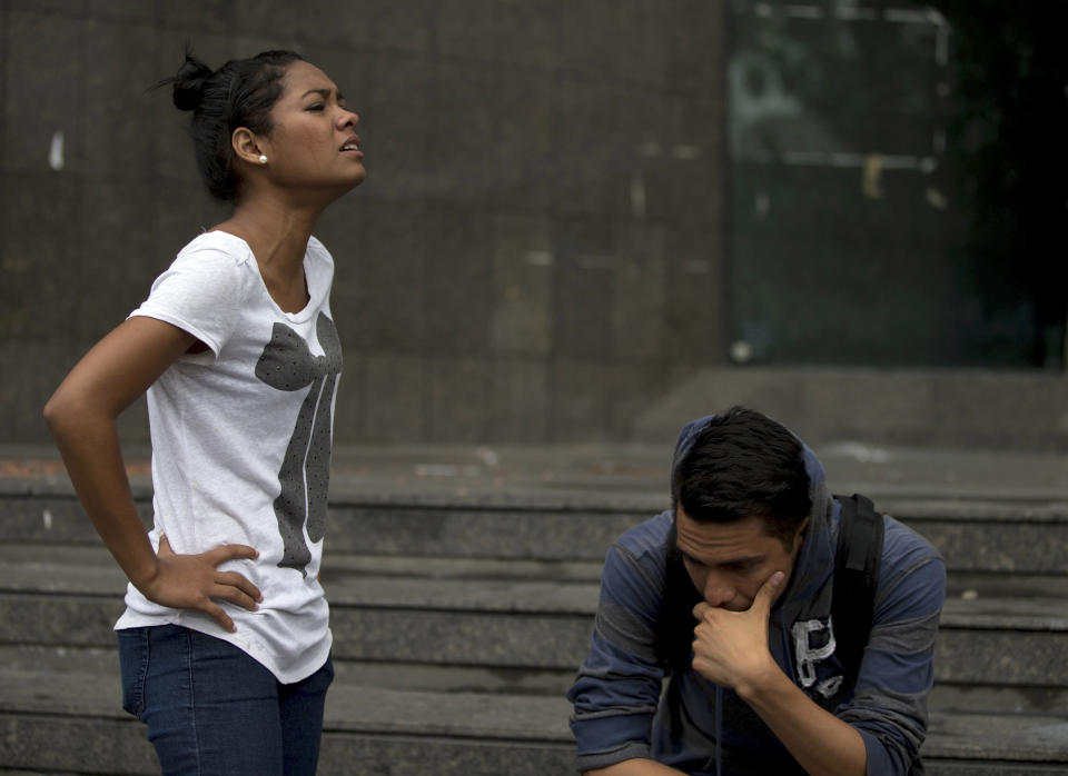 A female student cries after learning that fellow students maintaining a camp near the United Nations headquarters, were arrested in a pre-dawn raid, in Caracas, Venezuela, Thursday, May 8, 2014. Hundreds of security forces broke up four camps maintained by student protesters, arresting more than 200 people. The camps consisting of small tents were installed more than a month ago in front of the UN building and other anti-government strongholds in the capital to protest against President Nicolas Maduro's government. (AP Photo/Fernando Llano)