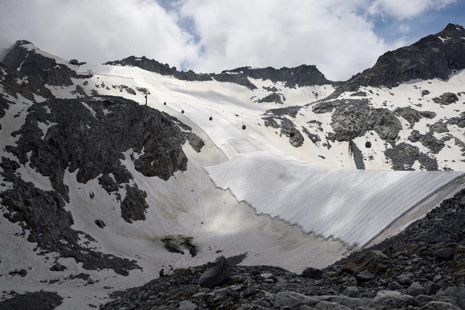 mountain snow glacier covered in white sheets beneath ski lift