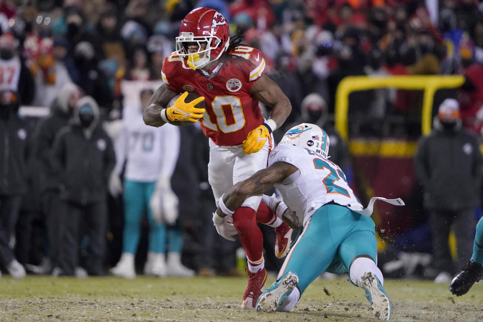 Kansas City Chiefs running back Isiah Pacheco (10) runs against Miami Dolphins safety DeShon Elliott during the first half of an NFL wild-card playoff football game Saturday, Jan. 13, 2024, in Kansas City, Mo. (AP Photo/Ed Zurga)