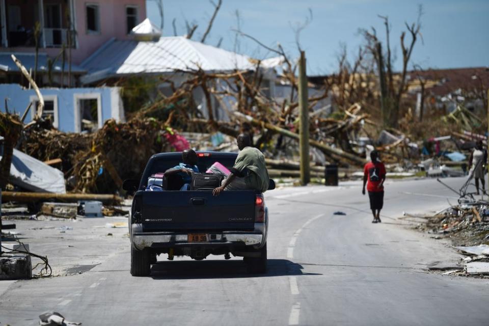 Residents pass damage caused by Hurricane Dorian on Sept. 5, 2019, in Marsh Harbour, Great Abaco Island in the Bahamas. | Brendan Smialowski—AFP/Getty Images