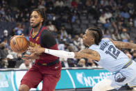 Cleveland Cavaliers Darius Garland (10) dribbles the ball as Memphis Grizzlies guard Ja Morant (12) reaches for it during the first half of an NBA basketball game Wednesday, Oct. 20, 2021, in Memphis, Tenn. (AP Photo/Nikki Boertman)