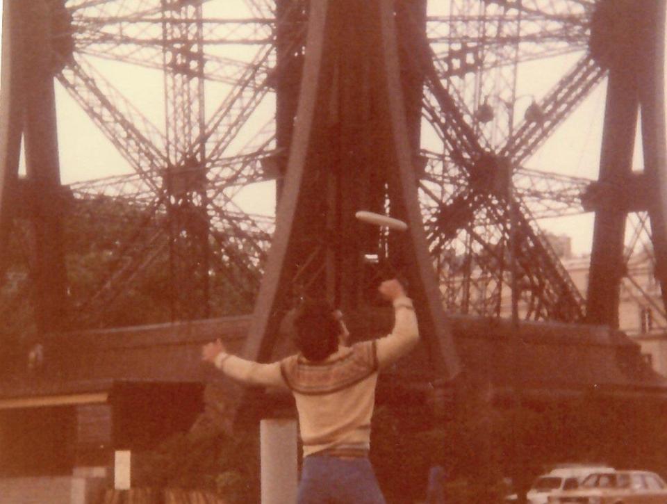 Paul Kenny plays Frisbee in 1980 at the Eiffel Tower in Paris.