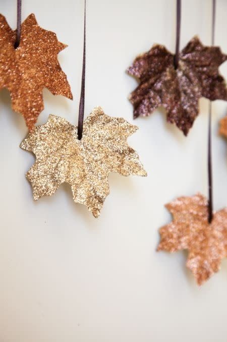 <p>This craft is not only beautiful, but also takes 10 minutes to put together. </p><p><strong>Get the tutorial at <a rel="nofollow noopener" href="http://decorenvy.co.uk/diy-projects/make-your-own-autumn-leaves-garland/" target="_blank" data-ylk="slk:Decor Envy;elm:context_link;itc:0;sec:content-canvas" class="link ">Decor Envy</a>.</strong><br></p><p><strong>What you'll need: </strong>Artificial leaves ($10, <a rel="nofollow noopener" href="https://www.amazon.com/Artificial-MerryNine-Multicolor-Decorations-Leaves-300pcs/dp/B01M1IEN0P" target="_blank" data-ylk="slk:amazon.com;elm:context_link;itc:0;sec:content-canvas" class="link ">amazon.com</a>), Metallic colors glitter ($5, <a rel="nofollow noopener" href="https://www.amazon.com/EK-5-Pack-Glitter-Metallic-Colors/dp/B00C90WRS2" target="_blank" data-ylk="slk:amazon.com;elm:context_link;itc:0;sec:content-canvas" class="link ">amazon.com</a>)</p>