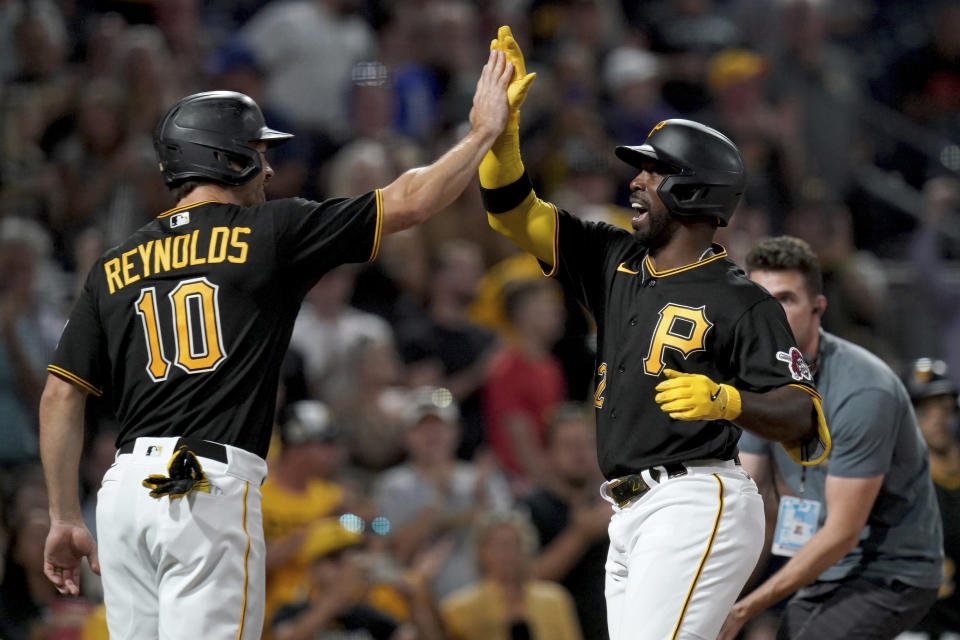 Pittsburgh Pirates' Andrew McCutchen celebrates with Bryan Reynolds after he hit a two-run home run off St. Louis Cardinals starting pitcher Adam Wainwright in the fifth inning of a baseball game in Pittsburgh, Tuesday, Aug. 22, 2023. (AP Photo/Matt Freed)