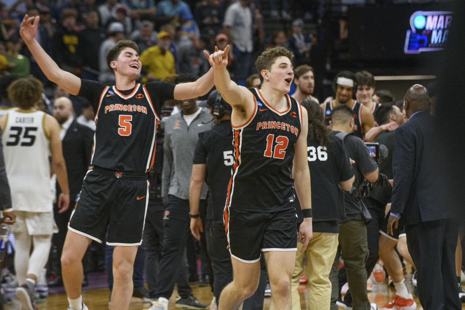 Princeton guard Ryan Langborg (3) and forward Caden Pierce (12) celebrate the team's win in a second-round college basketball game against Missouri in the men's NCAA Tournament in Sacramento, Calif., Saturday, March 18, 2023. Princeton won 78-63. (AP Photo/Randall Benton)