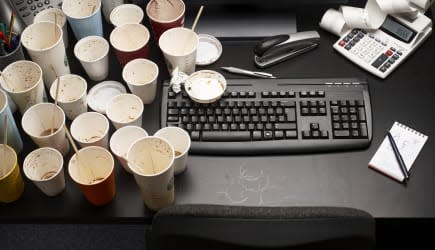 Empty coffee cups on office desk, high angle view