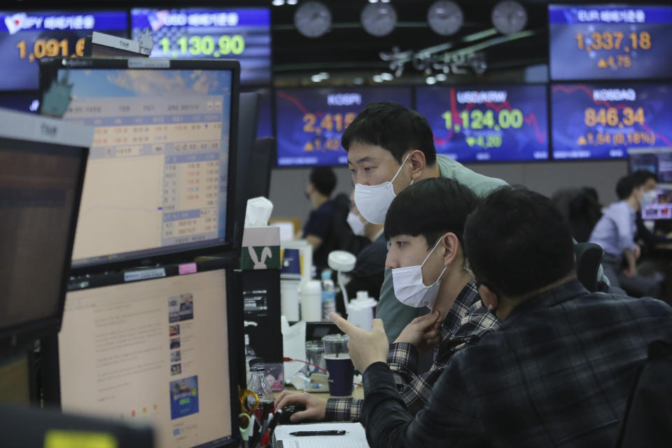 Currency traders watch monitors at the foreign exchange dealing room of the KEB Hana Bank headquarters in Seoul, South Korea, Friday, Nov. 6, 2020. Asian stock markets were mixed Friday after Wall Street rose amid protracted vote-counting following this week's U.S. elections. (AP Photo/Ahn Young-joon)