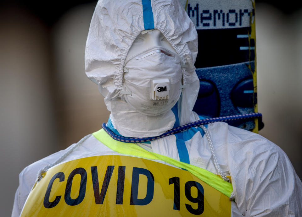 An advertising figure for Covid-19 rapid test stands in front of a small test center in Frankfurt, Germany, Sunday, March 7, 2021. From Monday on free corona tests are offered in Germany. (AP Photo/Michael Probst)