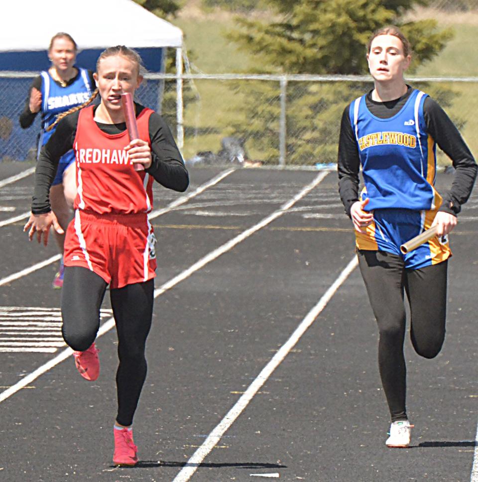 Anchor runners Sadie Johnson of Estelline-Hendricks (left) and Presley Knecht of Castlewood sprint to the finish in the girls' 800-meter relay during the Estelline Alumni Track and Field meet on Tuesday, April 23, 2024.