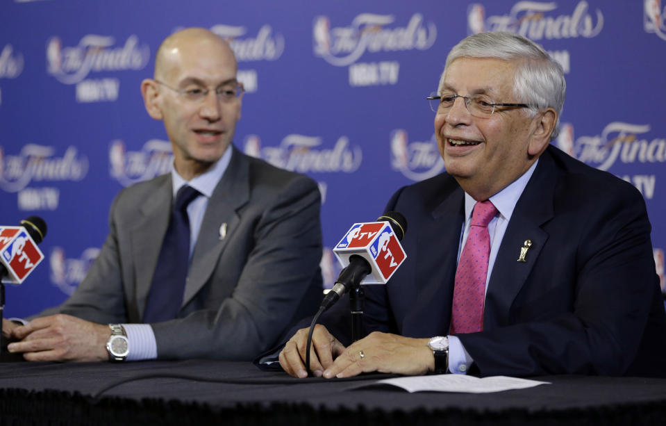 FILE - In this Thursday, June 6, 2013 file photo, David Stern, NBA Commissioner, right, and Adam Silver, Deputy Commissioner, speak before the start of Game 1 of the NBA Finals basketball game between the San Antonio Spurs and Miami Heat in Miami. David Stern, who spent 30 years as the NBA's longest-serving commissioner and oversaw its growth into a global power, has died on New Year’s Day, Wednesday, Jan. 1, 2020. He was 77. (AP Photo/Wilfredo Lee, File)