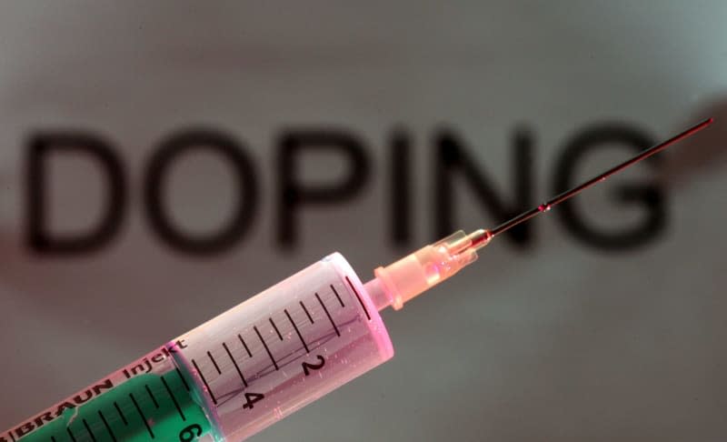 A syringe can be seen in front of the word doping. Patrick Seeger/Deutsche Presse-Agentur GmbH/dpa