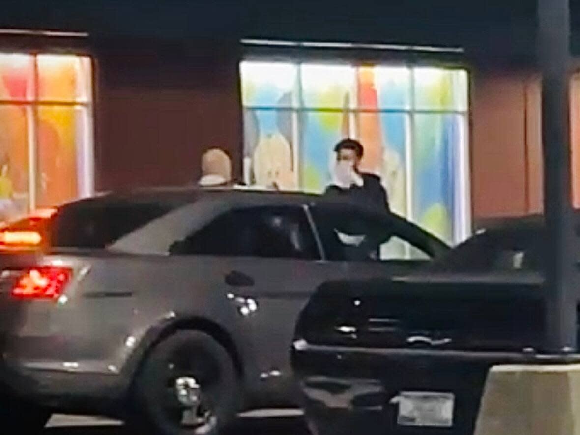 Witnesses say the video appears to show a Surrey RCMP officer throwing papers at a man's face.  (Submitted by Amreek Singh - image credit)