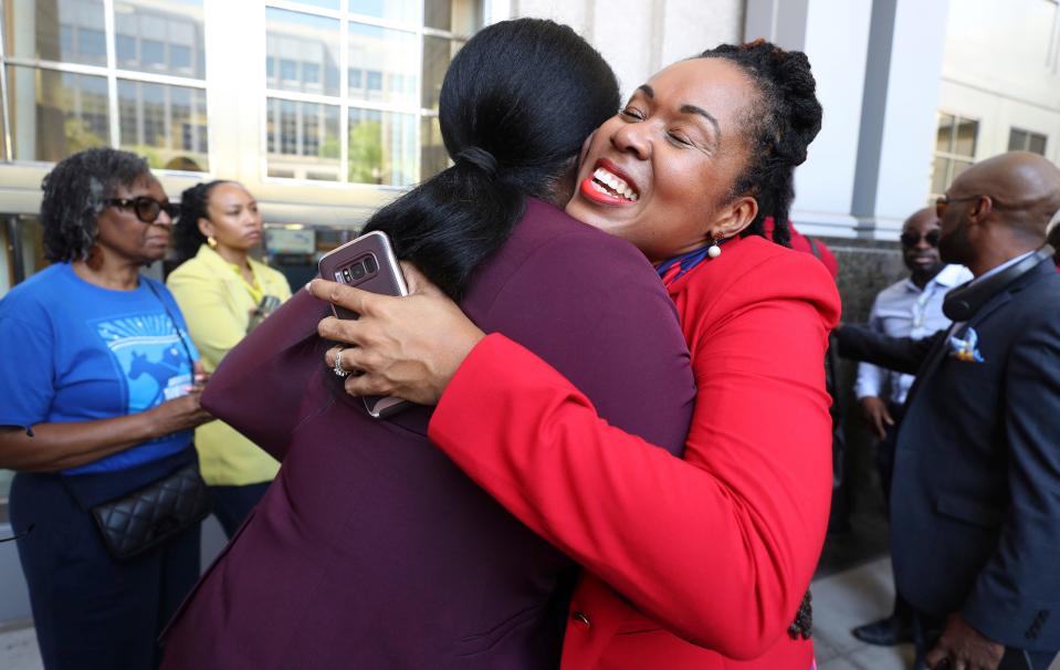 Attorney Monique Worrell of the 9th Judicial Circuit, right, which serves Orange and Osceola counties, gets hugs from supporters after a press conference, Wednesday, Aug. 9, 2023, outside her former office in the Orange County Courthouse complex in Orlando, Fla. Florida Gov. Ron DeSantis suspended Worrell on Wednesday, again wielding his executive power over local government in taking on a contentious issue in the 2024 presidential race. Worrell vowed to seek reelection next year and said her removal was political and not about her performance. (Ricardo Ramirez Buxeda/Orlando Sentinel via AP)