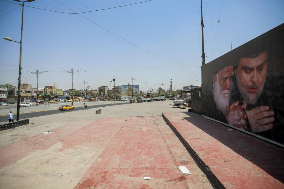 A poster depicting Muqtada al-Sadr, right, and his father, Mohammed Sadiq al-Sadr are displayed in Sadr City, Baghdad, Iraq, Thursday, Aug. 4, 2022. Residents of the impoverished Baghdad suburb of Sadr City say they they support an influential Shiite cleric who called on thousands of his followers to storm Iraq's parliament. (AP Photo/Anmar Khalil)